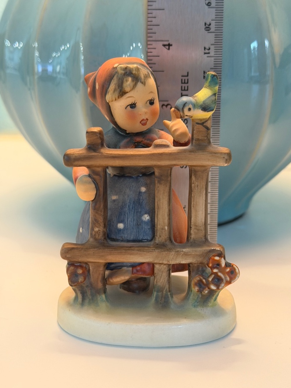 Hummel Figurine Girl at Fence with Blue and Orange Accents